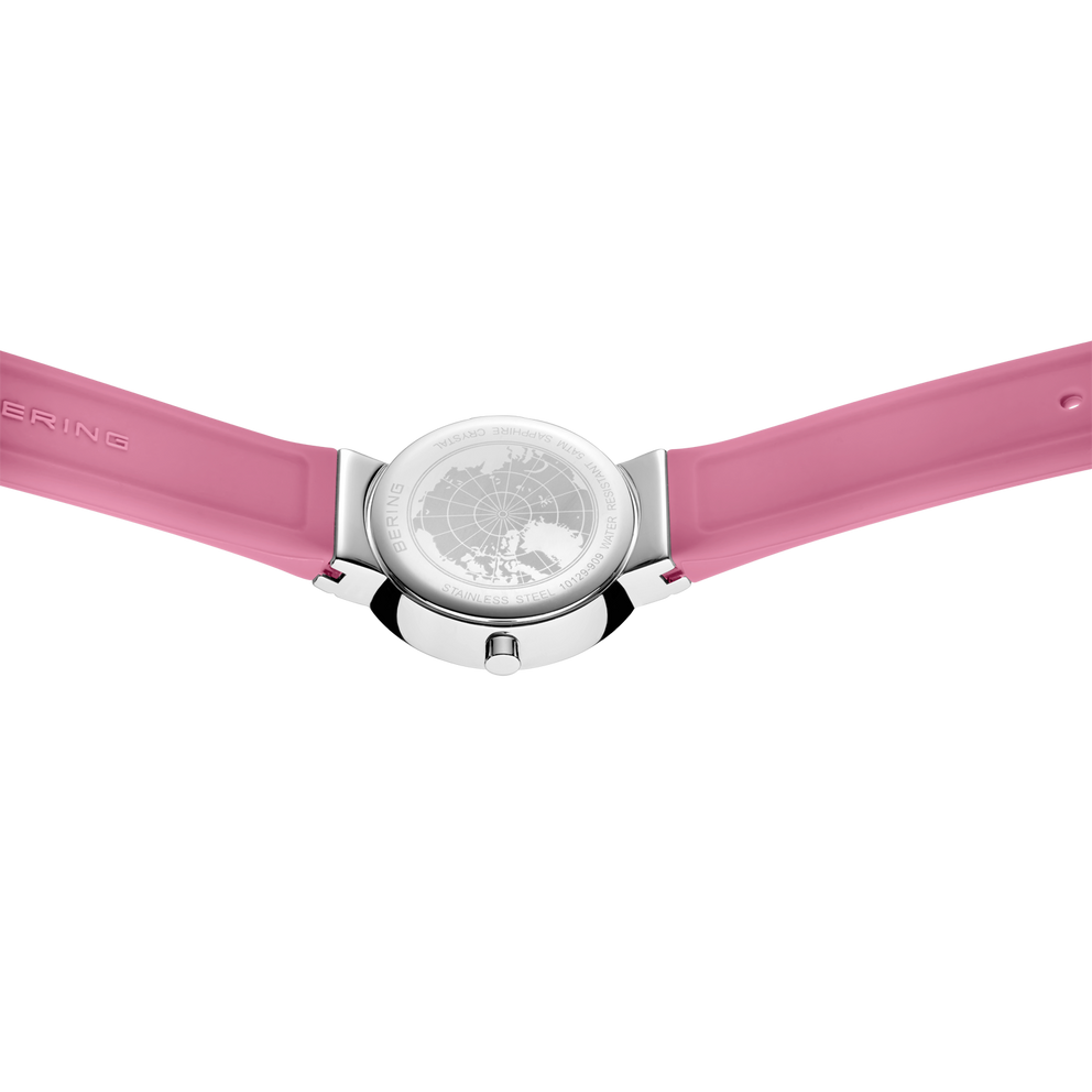 Round silver watch with textured dial and pink fabric straps, viewed from above