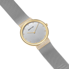 BERING wristwatch with light dial, gold-tone case and mesh bracelet, shown at an angle displaying the side profile.