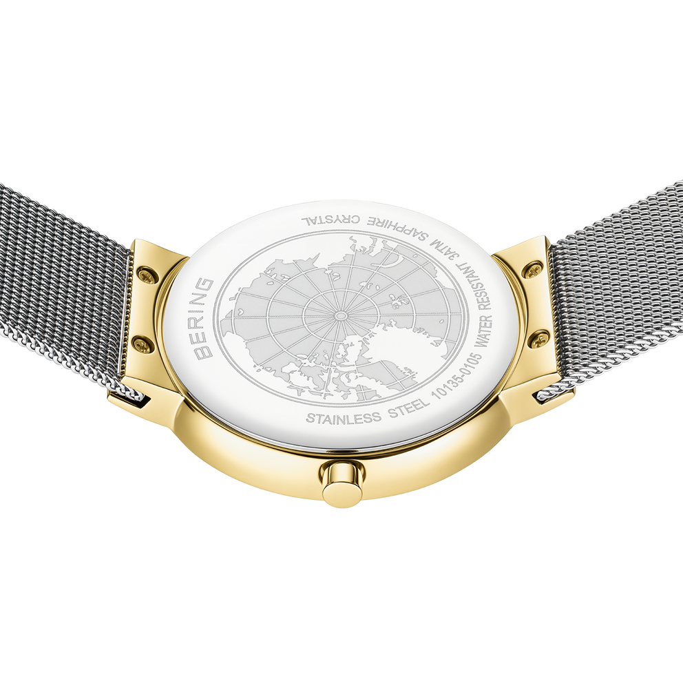 BERING watch with white dial and world map design, gold-tone case accents, and dark mesh bands, viewed from above