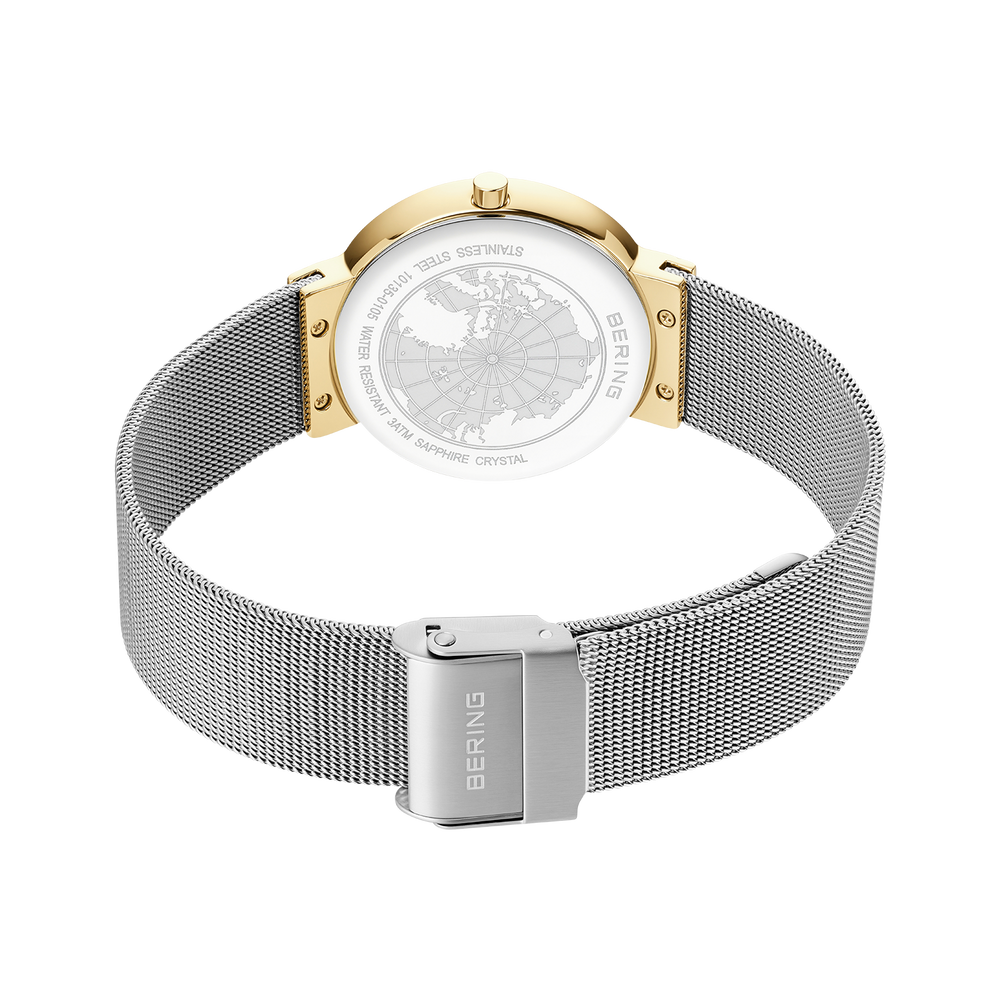 Watch caseback with engraved decoration, silver mesh strap and gold-tone lugs, rear view