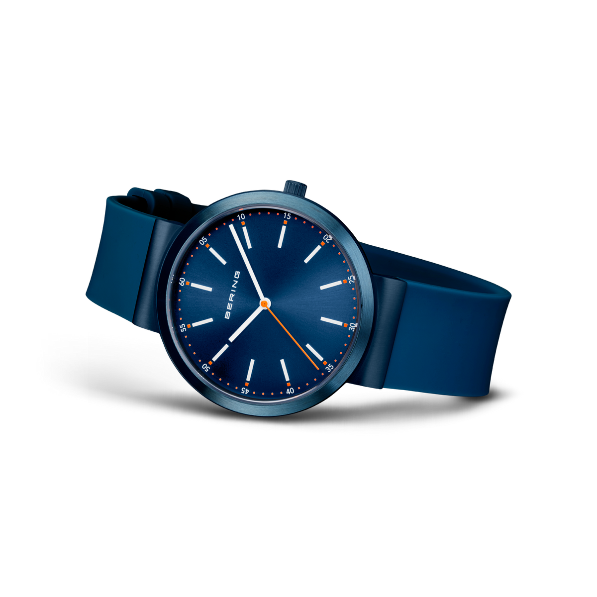 Navy dial watch with white indices and hands, blue fabric strap, shown at an angle.