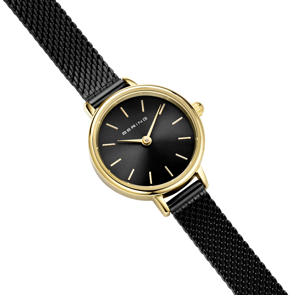 Round BERING wristwatch at angled view: gold case, black dial with thin hour markers, gold-tone hands, black mesh band.