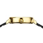 Gold-toned watch case with black leather strap, viewed from above
