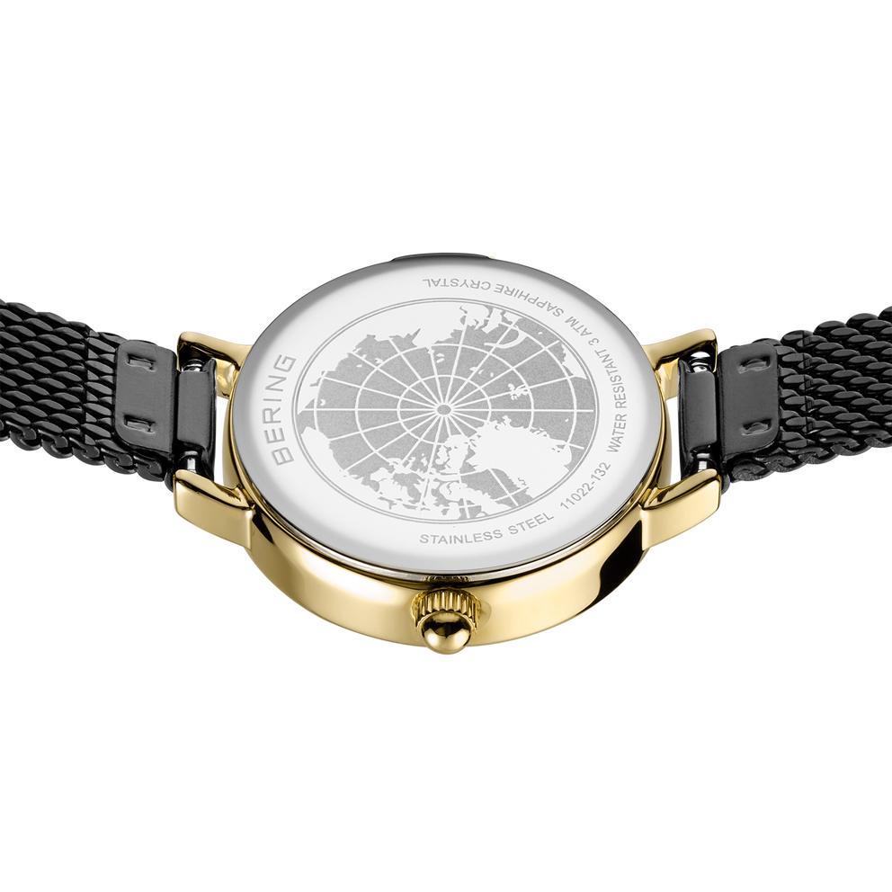 Watch with world map dial, gold case, and black mesh band