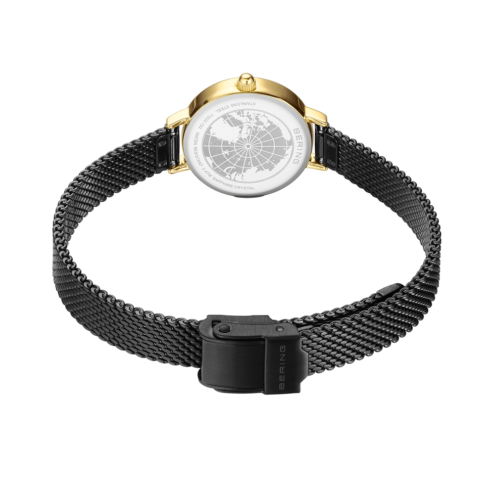 BERING 11022-132 watch viewed from behind, showing black mesh bracelet with rectangular push-clasp and gold-plated case bezel