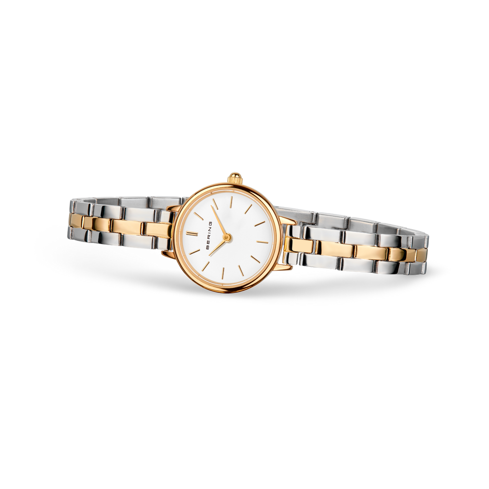 Montre BERING avec bracelet deux-tons or rose et acier, cadran blanc avec index épurés, vue de face.
