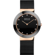 BERING wristwatch with dark gray round case, black dial with dot hour markers, rose-gold hands, and black mesh metal band.
