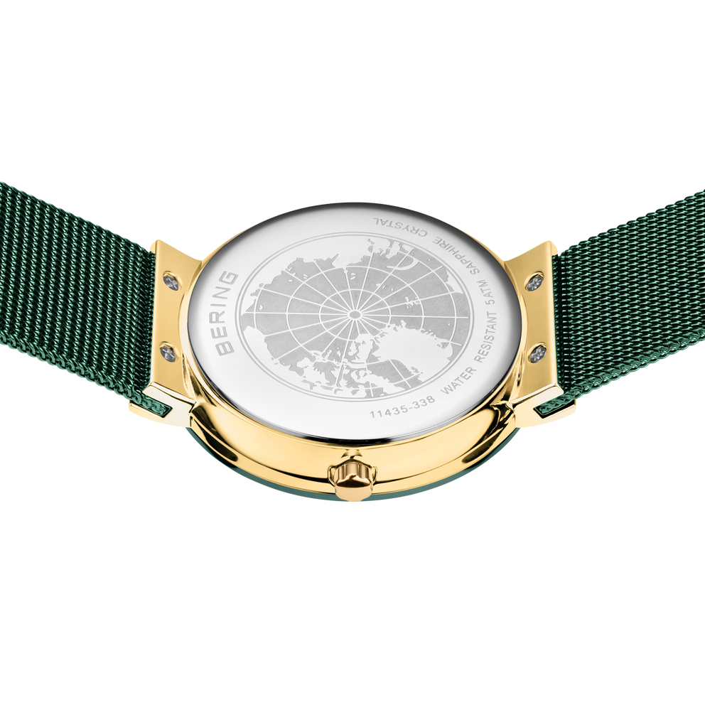 Orologio visto dall'alto con quadrante bianco, disegno mappa mondiale, cassa dorata e cinturino mesh verde