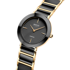 Orologio da polso BERING bicolore con quadrante raggiato scuro e bracciale a maglie oro e nero.