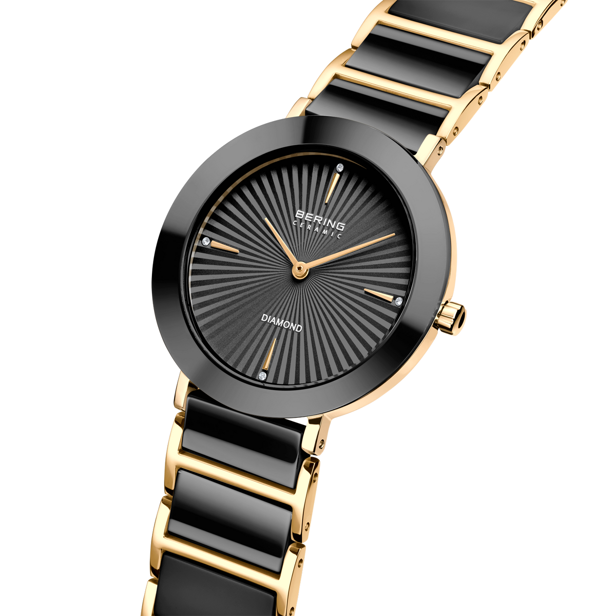 Orologio da polso BERING bicolore con quadrante raggiato scuro e bracciale a maglie oro e nero.