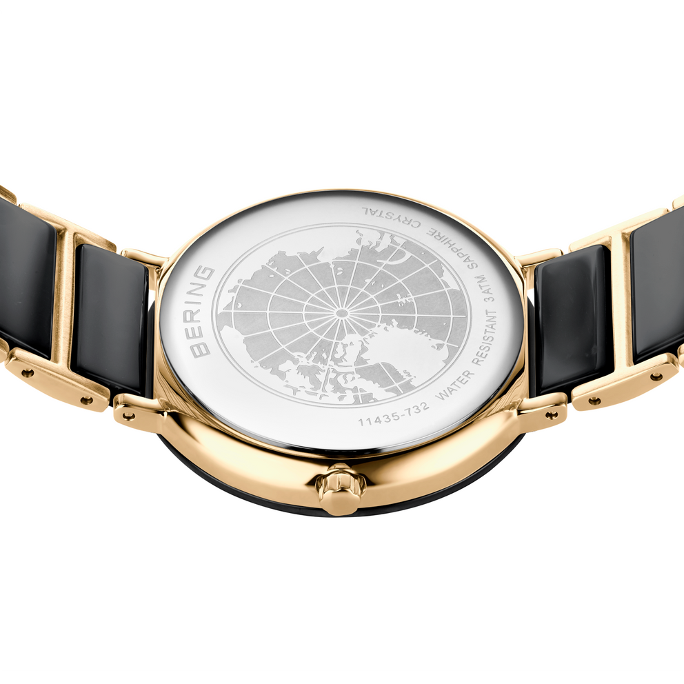 Orologio color oro con cinturino nero e quadrante bianco con design a mappa mondiale, vista dall'alto