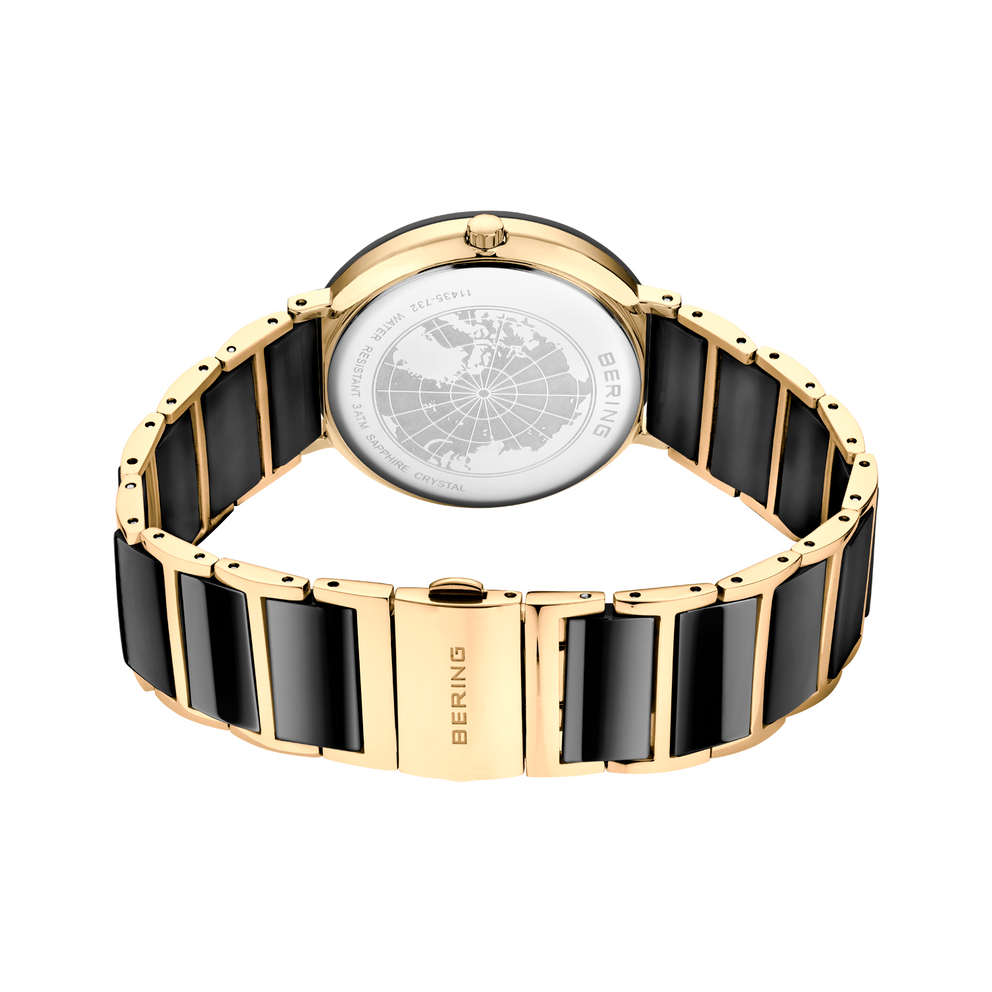 Retro dell'orologio con fondello trasparente che mostra il meccanismo, cinturino nero e oro
