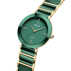 Orologio BERING con quadrante teal e motivo a linee radiali, cassa teal e cinturino con maglie alternate teal e color oro