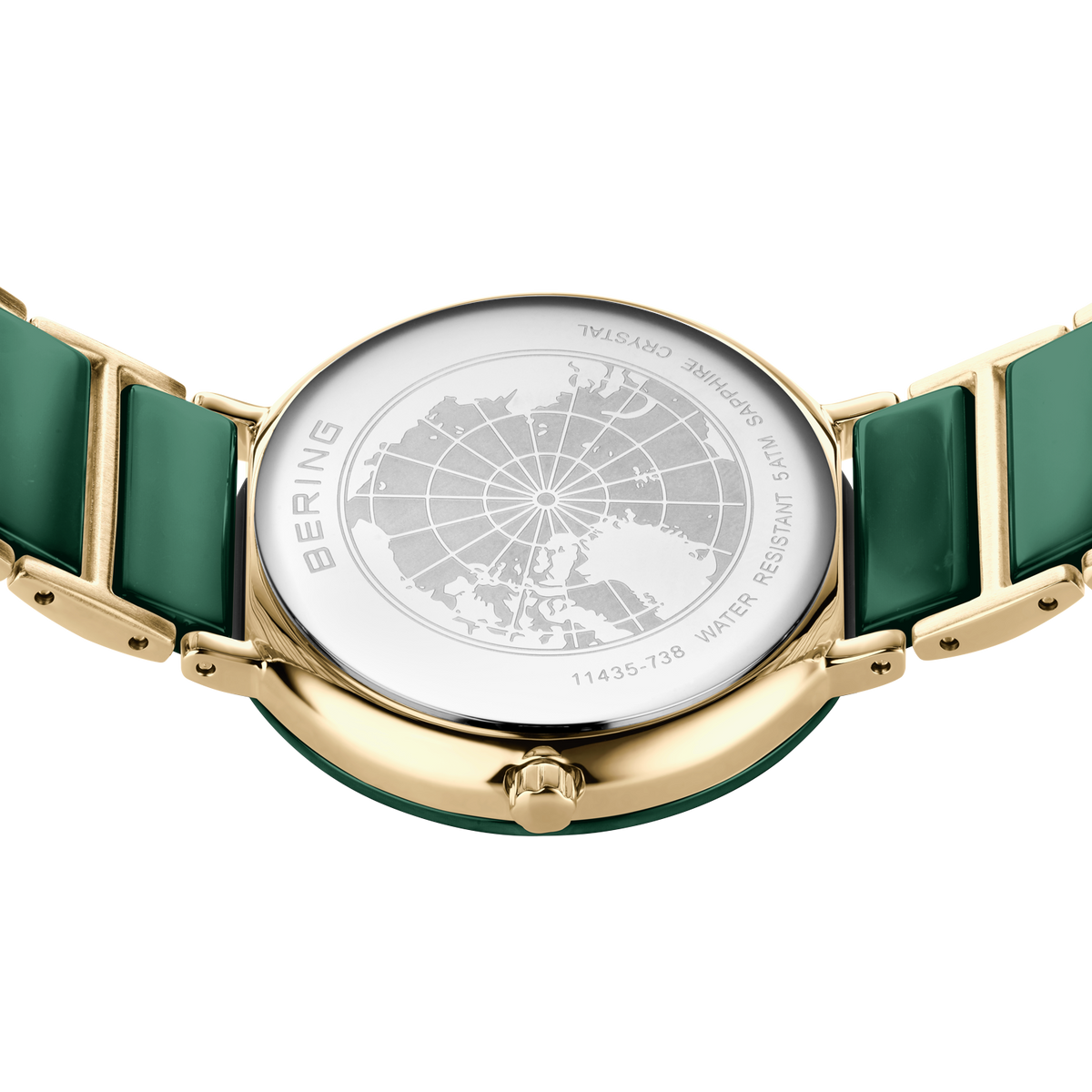 Orologio color oro con cinturino verde, visto dall'alto con cassa trasparente che rivela il quadrante mappamondo.
