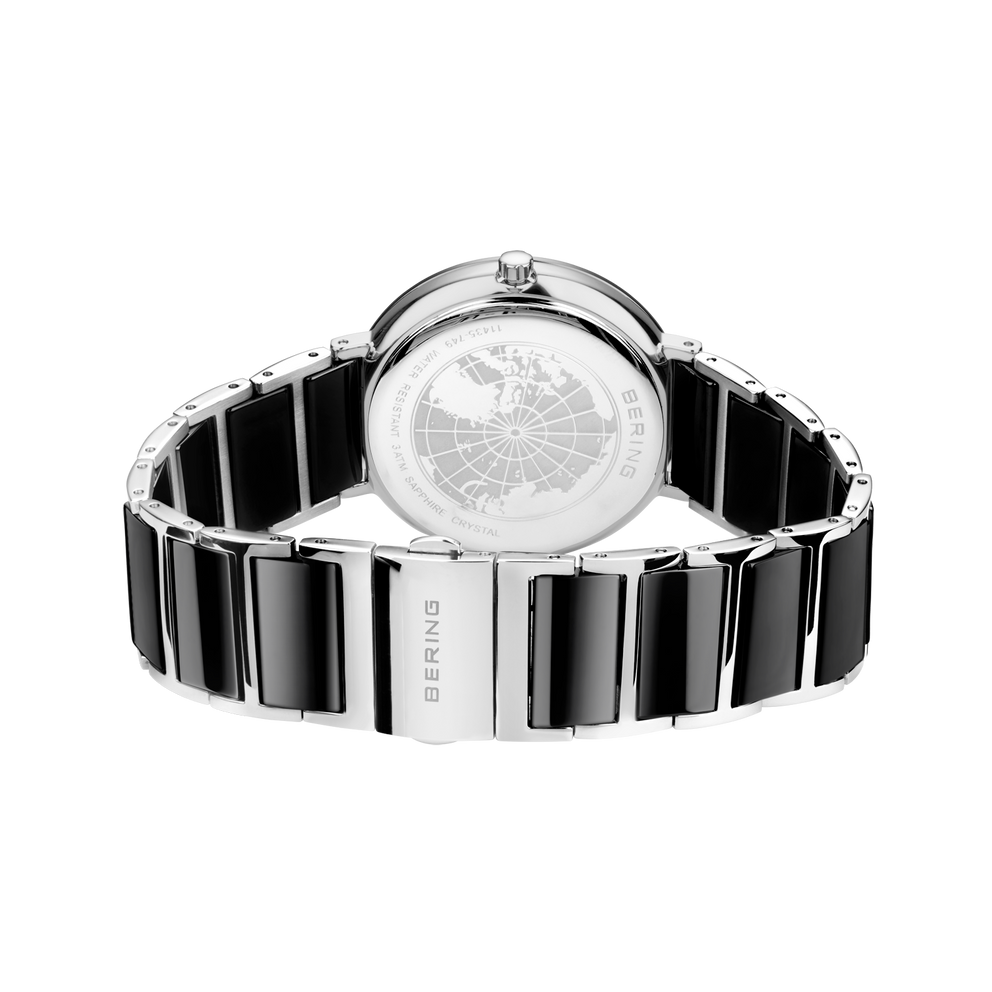 Orologio da polso vista posteriore, quadrante bianco con motivo decorativo, cinturino bicolore nero-argento