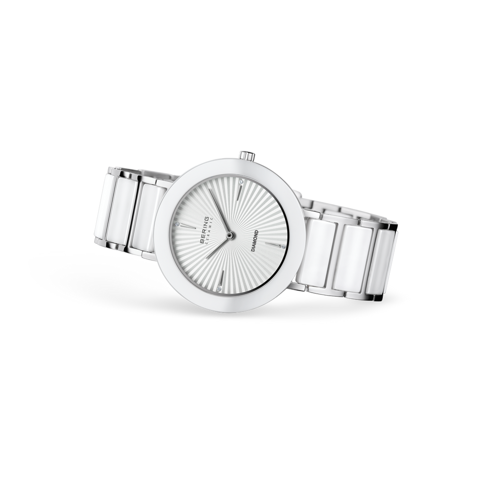 Silver wristwatch with round white dial, radial index markers, and metal bracelet, side view
