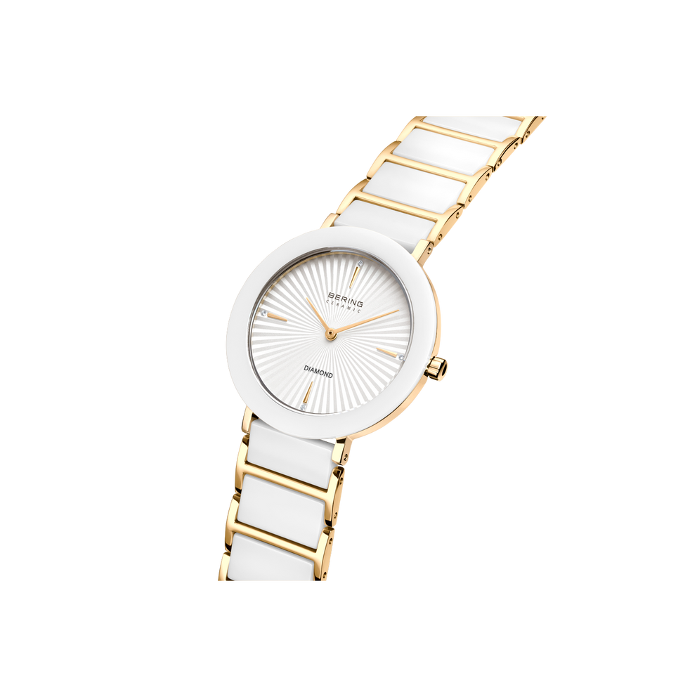 BERING wristwatch with white ceramic case, sunburst dial, and two-tone gold-and-white segmented bracelet