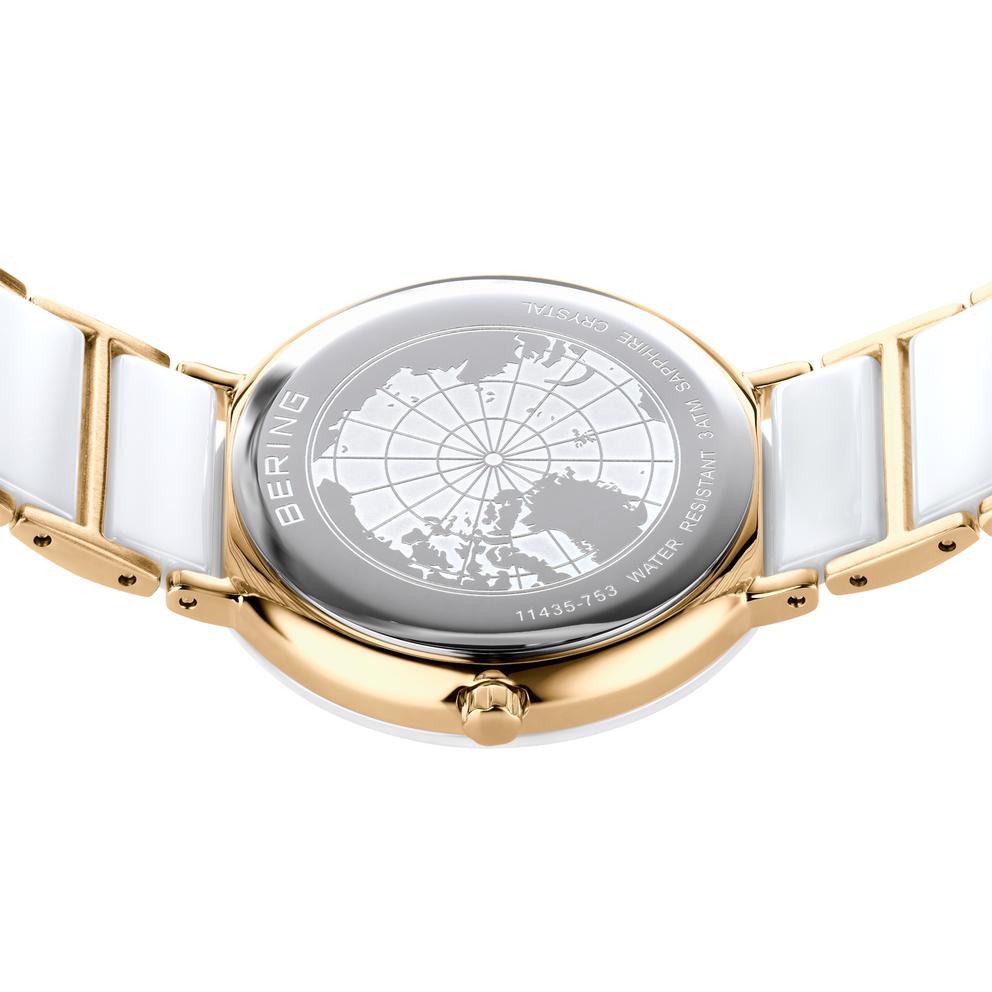 Two-tone wristwatch with world map dial, photographed from above. Gold case and bracelet links alternate with white segments.