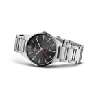 Dark gray dial watch with three hands and date window, silver-tone stainless steel link bracelet, photographed at an angle.