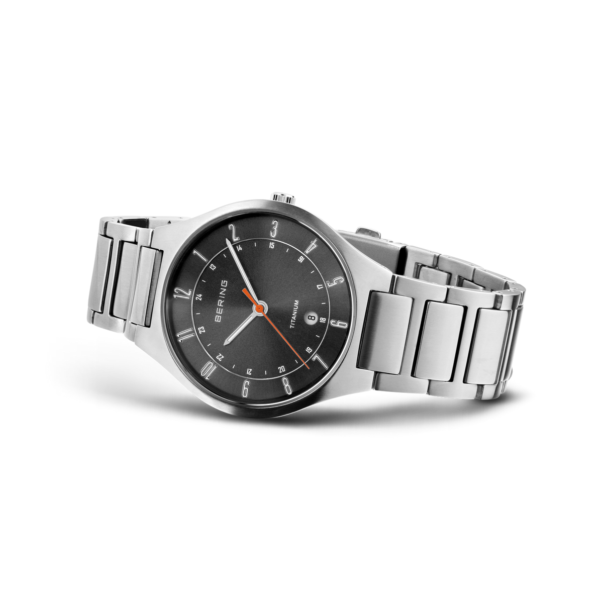 Dark gray dial watch with three hands and date window, silver-tone stainless steel link bracelet, photographed at an angle.