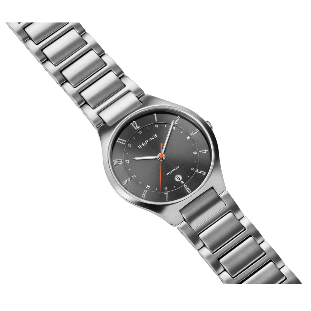 Gray dial wristwatch with steel link bracelet, angled view showing bracelet and case.