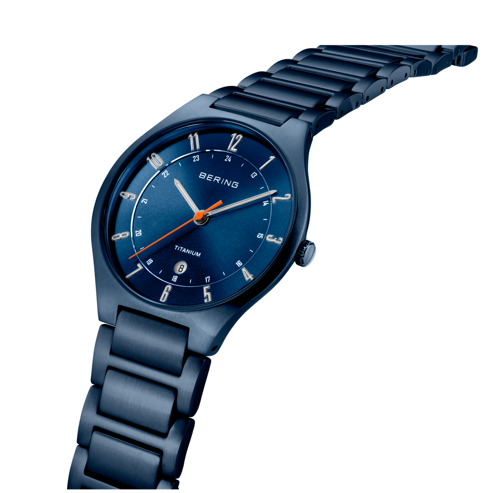 BERING wristwatch with navy dial and metal bracelet, angled side view.