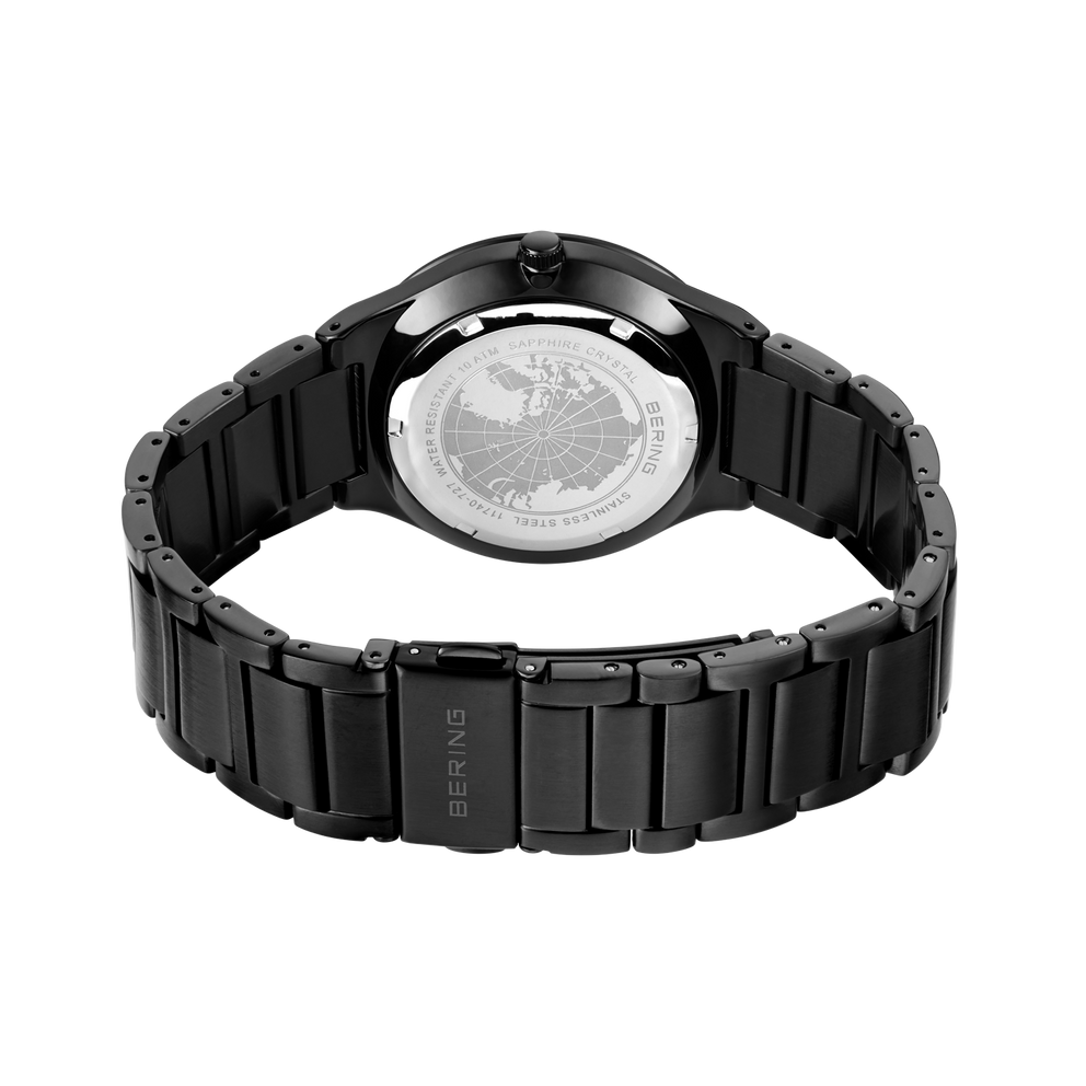 Black wristwatch with metal link bracelet, photographed from behind to show the case back and band detail.