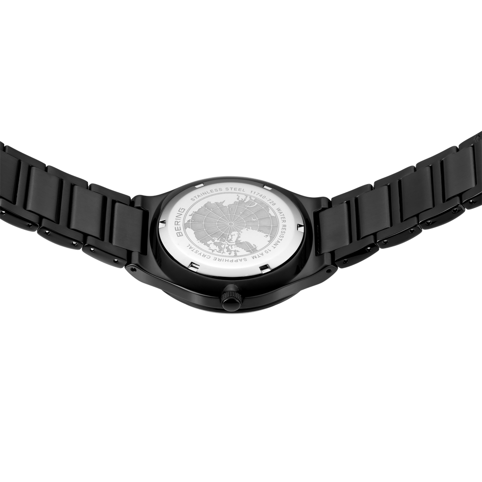 Black wristwatch with round white dial, angled overhead view
