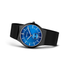 BERING wristwatch with blue dial, white indices, and subdial, black mesh band, angled view
