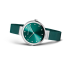 BERING wristwatch with teal dial, silver case, and teal mesh strap shown at three-quarter angle.
