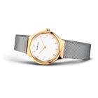 Gold-toned round watch with white dial, minimal hour markers, grey mesh strap, three-quarter view