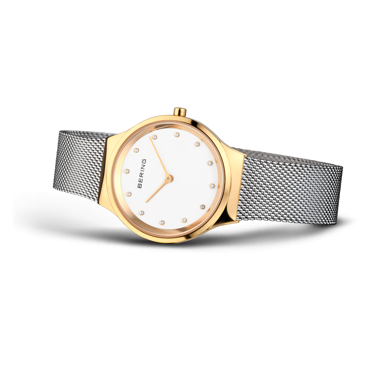 Gold-toned round watch with white dial, minimal hour markers, grey mesh strap, three-quarter view
