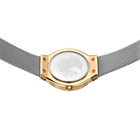 Watch from above showing white face, gold case, and metal mesh band