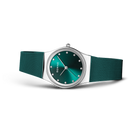BERING wristwatch with teal dial and silver case, shown at angle with teal mesh bracelet.