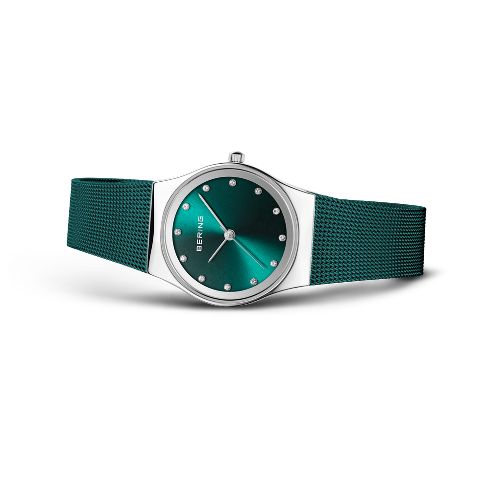 BERING wristwatch with teal dial and silver case, shown at angle with teal mesh bracelet.