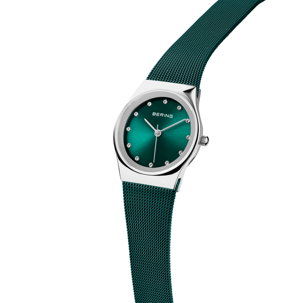 BERING watch 12927-808, angled side view with teal dial, diamond indices, and matching mesh strap.