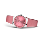 Round pink wristwatch with mesh band, angled three-quarter view