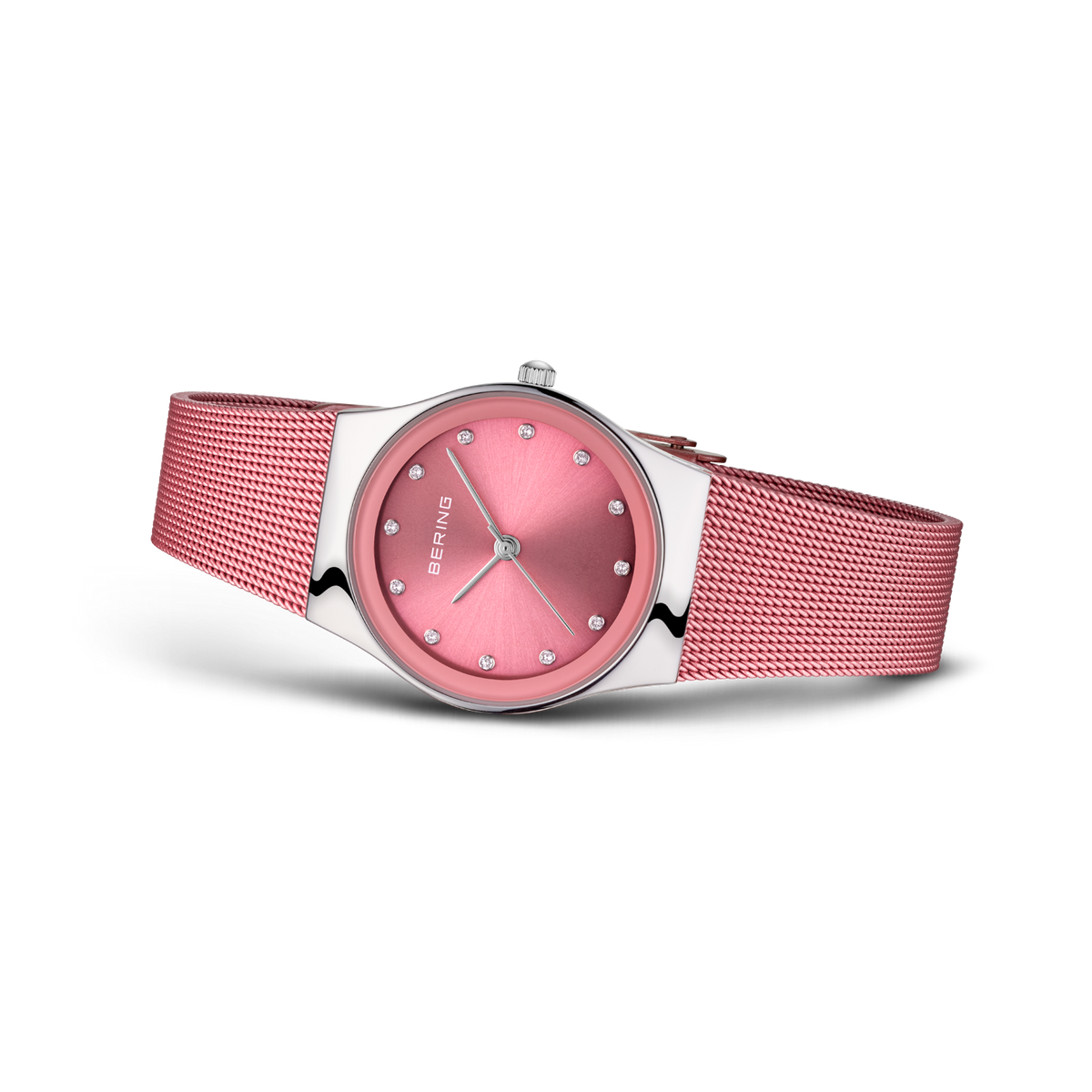 Round pink wristwatch with mesh band, angled three-quarter view