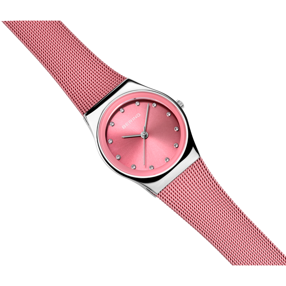 BERING wristwatch with pink dial and red textured fabric strap, shown at an angle on white background