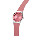 Wristwatch with rose-pink dial, silver case, and matching rose-pink mesh band draped across the watch case.