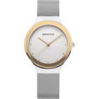 Montre BERING ronde avec boîtier or champagne, cadran blanc et bracelet en maille, vue de face.