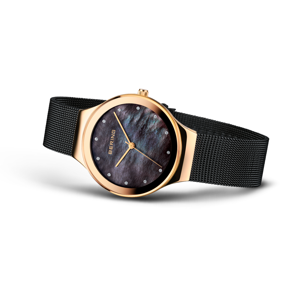 BERING wristwatch with rose gold round case, dark blue dial, and black mesh band, three-quarter angle view