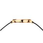 Gold wristwatch viewed from the side, showing polished case and black textured strap.