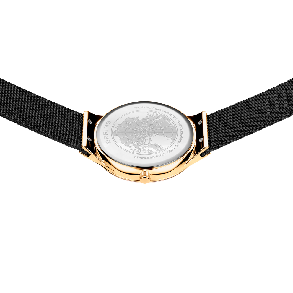 Watch caseback with BERING engraving, gold-tone case, black fabric strap