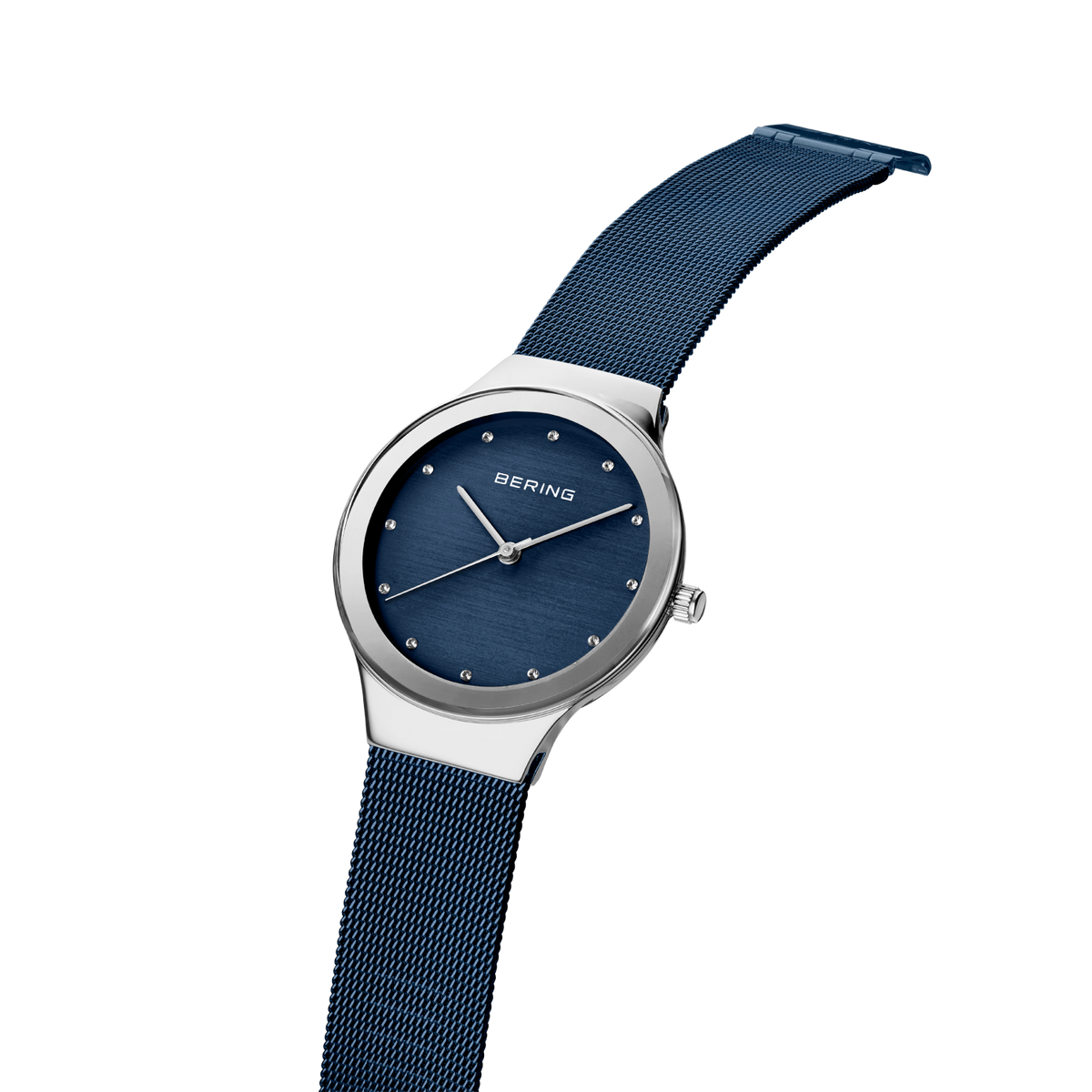 BERING wristwatch with silver case, dark blue dial, and matching mesh band, tilted to show band texture and side profile.
