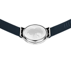 Watch viewed from above, showing dark fabric strap extended on both sides and metallic case