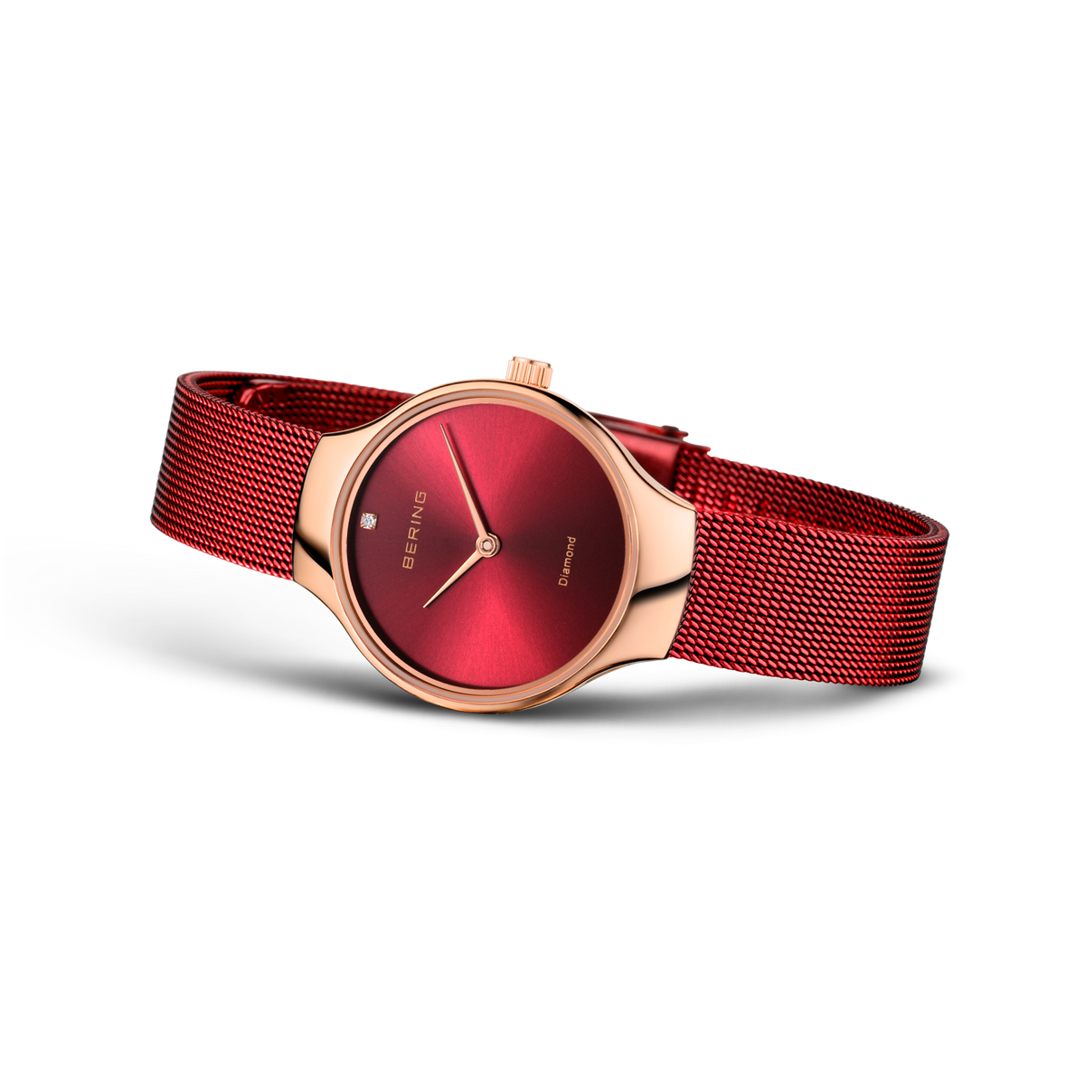 BERING Charity wristwatch with rose gold case, deep red dial, and matching red mesh strap, angled view.