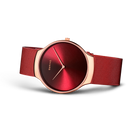 BERING Charity wristwatch with deep red dial and red mesh band, shown at an angle.