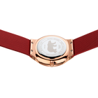 Rose gold watch case with white dial and deep red fabric strap, viewed from below to show the transparent case back.