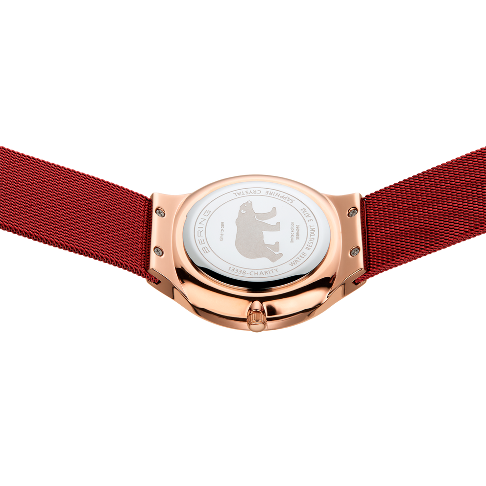 Rose gold watch case with white dial and deep red fabric strap, viewed from below to show the transparent case back.